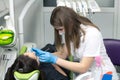 Dentist at work examining woman`s teeth Royalty Free Stock Photo