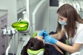 Dentist at work examining woman`s teeth Royalty Free Stock Photo