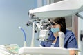 The dentist works on a dental microscope in a dental clinic