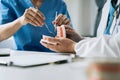 Dentist writing report working with tooth x-ray film model and equipment used in the treatment of dental Royalty Free Stock Photo