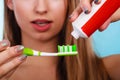 Woman applying toothpaste on her toothbrush Royalty Free Stock Photo