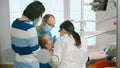 Stomatologist doctors treating dental problems of child