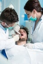 Dentistry education. Male dentist doctor teacher explaining treatment procedure.