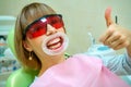 Dentistry happy patient in the chair in goggles