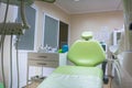 Professional dental unit with green chair and tools. Dentistry, medicine, medical equipment and stomatology concept