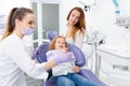 Dentists examining little girl Royalty Free Stock Photo