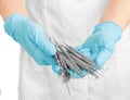 A dentists hands in blue medical gloves with dental tools Royalty Free Stock Photo