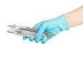 A dentists hands in blue medical gloves with dental tools Royalty Free Stock Photo