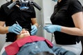 Dentists making medical examination with microscope