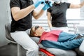 Dentists making medical examination with microscope