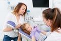 Dentists making treatment for little girl