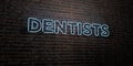 DENTISTS -Realistic Neon Sign on Brick Wall background - 3D rendered royalty free stock image