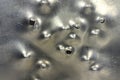 Dents from falling bullets in aluminum sheet t background