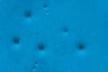 Dents pattern, holes or bullet shot marks on the blue metal surface of the old background iron texture Royalty Free Stock Photo