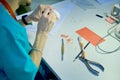 Dentures in the hands of a male dentist doctor. The prosthetist is working on the creation of a false jaw