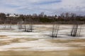 Denuded trees growing out of colourful half-frozen LÃÂ©on-Provencher marsh in early spring Royalty Free Stock Photo