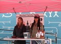 Two beautiful girls selling wine in the wine tasting booth at the Spring Bazaar in RINO Art District.