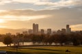 The Denver Colorado skyline as seen from City Park, as the sun casts golden light on the park Royalty Free Stock Photo