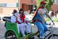Denver, Colorado, USA - July 1, 2017: Duffman driving two geishas in a pedicab at Denver Comic Con