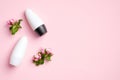 Deodorant antiperspirant bottles with flowers on pink background. Flat lay, top view. Underarm skin care, sweat protection concept Royalty Free Stock Photo