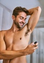 Deodorant, man or spray armpit after shower in home for hygiene, male grooming or perfume to control sweating. Happy Royalty Free Stock Photo