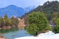 Deoria or Deoriya Tal Lake, Blue Himalayan Mountain, Lush Green Trees and Snow - Winter Landscape in Himalayas, Uttarakhand, India Royalty Free Stock Photo