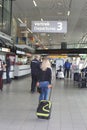 Departing passengers and information desk at Amsterdam Schiphol airport, Netherlands Royalty Free Stock Photo