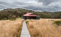 A department of conservation hut perched on the plains in new zealand native bush