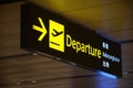 Departure sign hangs over busy travellers at Changi Airport Terminal 1 departure hall Royalty Free Stock Photo