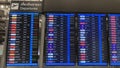Departures board at airport terminal showing flights