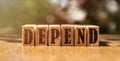 DEPEND word made with building wooden blocks