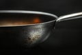 Depicting close up of the smooth surface texture of steel pan, black background, soft light Royalty Free Stock Photo