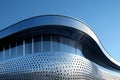 Depicting low angle view of a curved metal building facade, with a minimalistic design featuring parametric patterns inspired Royalty Free Stock Photo