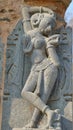 Depiction of beautiful, ancient, artistic woman by digging on stone. arthuna temple, rajasthan, India