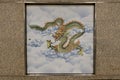 Depiction of a Green Dragon, one of the four great beasts in Chinese mythology, on the wall tiles of a train station in East Asia