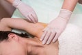 Depilation and epilation female armpit with liquid sugar paste by spatula. Hand of cosmetologist applying wax paste on armpit Royalty Free Stock Photo