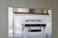 Depository sign on an exterior secured bank drop box