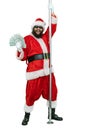 Depraved Santa is pole dancer, holds fan of dollars money. Lustful arabic young Santa Claus with black beard dances with Royalty Free Stock Photo
