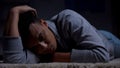 Depressed african-american teenager suffering loneliness in dark room, abuse