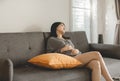 Depressed asian women sitting on sofa and thinking of divorce,Unhappy female arguing at house Royalty Free Stock Photo
