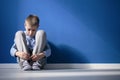 Depressed boy in a room Royalty Free Stock Photo