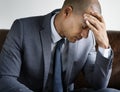 Depressed business man sitting on a couch Royalty Free Stock Photo