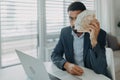 Depressed businessman man counting euro money working on computer at office desk and looking at camera, inflation Royalty Free Stock Photo