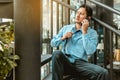 Depressed Businessman sitting on ground stairs and talking on phone suffering emotional stress Royalty Free Stock Photo