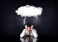 Depressed businessman sitting under a cloud