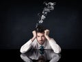 Depressed businessman with smoking head Royalty Free Stock Photo