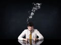 Depressed businessman with smoking head Royalty Free Stock Photo