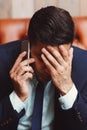 Depressed businessman talking on phone Royalty Free Stock Photo