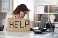 Depressed Businesswoman Holding Help Sign