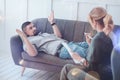 Depressed cheerless man lying on the sofa